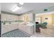 Cozy kitchen with white cabinets, open layout, and sink with view into the living room at 9333 Sw 97Th Pl # C, Ocala, FL 34481