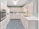 A bright kitchen featuring white cabinets, modern appliances, and plenty of counter space at 9333 Sw 97Th Pl # C, Ocala, FL 34481