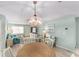 Bright and airy living area featuring a dining area, stylish furnishings, and beach-themed artwork at 9333 Sw 97Th Pl # C, Ocala, FL 34481