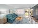 Inviting living room with a teal sofa, beach-themed decor, and lots of natural light at 9333 Sw 97Th Pl # C, Ocala, FL 34481