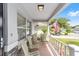 Inviting front porch features striped chairs and an American flag at 9333 Sw 97Th Pl # C, Ocala, FL 34481