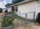 Fenced backyard featuring bushes, flowers, and the rear exterior at 9896 Sw 61St Ct, Ocala, FL 34476