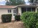 View of the exterior of the home with a small backyard area and green foliage at 9896 Sw 61St Ct, Ocala, FL 34476