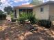 View of the backyard featuring partial screens in porch and landscaping at 9896 Sw 61St Ct, Ocala, FL 34476