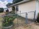 Fenced backyard featuring bushes, flowers, and the rear exterior at 9896 Sw 61St Ct, Ocala, FL 34476