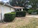 Landscaped backyard featuring a patio set and privacy bushes and fence at 9896 Sw 61St Ct, Ocala, FL 34476