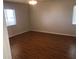 Bedroom with hardwood floors, fan, and windows providing natural light at 9896 Sw 61St Ct, Ocala, FL 34476