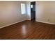 Bedroom with hardwood floors and a window leading to the bathroom at 9896 Sw 61St Ct, Ocala, FL 34476
