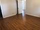 Bedroom with hardwood floors leading to another room at 9896 Sw 61St Ct, Ocala, FL 34476