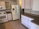 Well-organized kitchen with white appliances, ample storage, and tiled flooring at 9896 Sw 61St Ct, Ocala, FL 34476