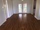 Bright living room boasts beautiful hardwood floors and French doors, creating an inviting space at 9896 Sw 61St Ct, Ocala, FL 34476