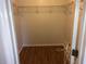 A walk-in closet with hardwood flooring and a wire shelving system for organized storage at 9896 Sw 61St Ct, Ocala, FL 34476