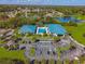 Stunning aerial view of community clubhouse, pool, and parking, surrounded by lush landscaping and neighborhood at 10824 Sw 90Th Ter, Ocala, FL 34481