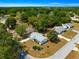 An aerial view of a charming single-story home with mature trees and landscaping in a tranquil neighborhood at 10824 Sw 90Th Ter, Ocala, FL 34481
