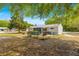 Spacious backyard featuring partial fence, view of screen room, and room for outdoor activities at 10824 Sw 90Th Ter, Ocala, FL 34481