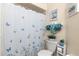 Bathroom featuring a butterfly-themed shower curtain and coordinated turquoise and gray towels at 10824 Sw 90Th Ter, Ocala, FL 34481