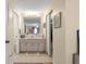 Bright bathroom featuring a sink vanity with storage and a large mirror, and tile floor at 10824 Sw 90Th Ter, Ocala, FL 34481