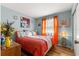 Cozy bedroom with lots of natural light, warm colored accents, and decorative wall art at 10824 Sw 90Th Ter, Ocala, FL 34481