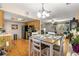 Kitchen and dining area with a table set for dining and hardwood flooring at 10824 Sw 90Th Ter, Ocala, FL 34481