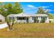 Charming single-story home with a welcoming front porch and well-maintained lawn at 10824 Sw 90Th Ter, Ocala, FL 34481