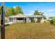 Inviting single-story home featuring a cozy porch, green shutters and well maintained lawn at 10824 Sw 90Th Ter, Ocala, FL 34481