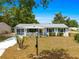 Charming single-story home featuring a cozy front porch and well-kept landscaping at 10824 Sw 90Th Ter, Ocala, FL 34481
