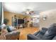 Comfortable living room featuring a ceiling fan, nice furniture, and hardwood floors at 10824 Sw 90Th Ter, Ocala, FL 34481