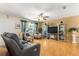 Cozy living room with a ceiling fan, hardwood floors and comfortable seating at 10824 Sw 90Th Ter, Ocala, FL 34481