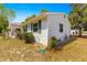 Side view of home with green shutters, landscaping, and a welcoming porch at 10824 Sw 90Th Ter, Ocala, FL 34481
