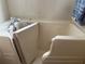 Bathroom walk in bathtub with tile, faucet, and towel at 10980 Sw 63Rd Ave, Ocala, FL 34476
