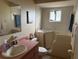Bathroom with safety tub, sink and vanity, toilet, and linen closet at 10980 Sw 63Rd Ave, Ocala, FL 34476