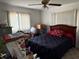 This bedroom is shown with a dark comforter and windows with vertical blinds at 10980 Sw 63Rd Ave, Ocala, FL 34476