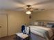 Bedroom with ceiling fan, natural light, decorated chairs, and comfortable sleeping arrangements at 10980 Sw 63Rd Ave, Ocala, FL 34476