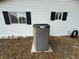 Exterior view showing Lennox HVAC system and white siding with black window shutters at 10980 Sw 63Rd Ave, Ocala, FL 34476