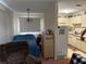 Cozy room with bedroom featuring a comfortable armchair with an adjacent view of the kitchen at 10980 Sw 63Rd Ave, Ocala, FL 34476