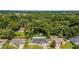 Aerial view showcasing the house, neighboring homes, and lush green surroundings in the neighborhood at 1109 Ne 22Nd Ave, Ocala, FL 34470