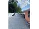 Long brick paved patio area leading to back shed with backyard including tree coverage at 1109 Ne 22Nd Ave, Ocala, FL 34470