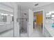 Gorgeous bathroom features a glass shower, dual sinks, and a door to main bedroom at 1109 Ne 22Nd Ave, Ocala, FL 34470