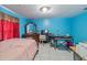 Bright bedroom with vibrant blue walls, tiled floors and ample room for furniture at 1109 Ne 22Nd Ave, Ocala, FL 34470