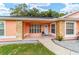 Inviting front porch with stone accents, tiled floor, and a charming entryway at 1109 Ne 22Nd Ave, Ocala, FL 34470