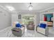 Spacious living room with marble floors, comfortable seating, and a bright, airy atmosphere at 1109 Ne 22Nd Ave, Ocala, FL 34470