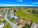 Stunning aerial view of a beautiful home nestled in a lush, green golf course community at 11799 Se 173Rd Lane Rd, Summerfield, FL 34491