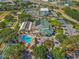 Aerial view of community clubhouse with a large pool, ample parking, and lush landscaping at 11799 Se 173Rd Lane Rd, Summerfield, FL 34491