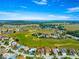 An impressive aerial perspective of a home in a golf course community with beautiful green surroundings at 11799 Se 173Rd Lane Rd, Summerfield, FL 34491