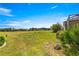 Serene backyard view featuring lush landscaping, a golf course, and beautiful neighborhood homes at 11799 Se 173Rd Lane Rd, Summerfield, FL 34491