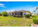 Expansive backyard featuring lush landscaping and a screened lanai at 11799 Se 173Rd Lane Rd, Summerfield, FL 34491