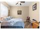 Cozy bedroom featuring a comfortable bed, ceiling fan, and warm, neutral tones at 11799 Se 173Rd Lane Rd, Summerfield, FL 34491