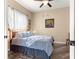 A cozy bedroom with a comfy bed, ceiling fan and a window with patterned curtains at 11799 Se 173Rd Lane Rd, Summerfield, FL 34491