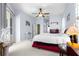 Bedroom with a ceiling fan, light blue walls, and glass table with adjacent sliding door at 11799 Se 173Rd Lane Rd, Summerfield, FL 34491