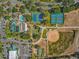 Overhead view of community amenities, showcasing tennis courts, a pool, and a well-maintained baseball field at 11799 Se 173Rd Lane Rd, Summerfield, FL 34491